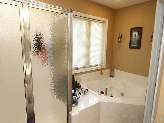 2504 Bulmer Terrace Raleigh, NC 27615 - Photo 7 of 12 a bathroom with a tub and a shower