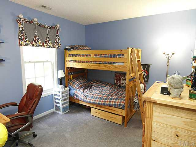 2504 Bulmer Terrace Raleigh, NC 27615 - Photo 10 of 12 a bed room with a bed chair and a window