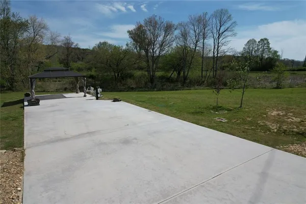 a view of a park with large trees