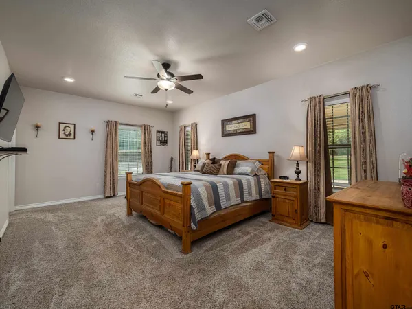 a bedroom with a bed and a ceiling fan