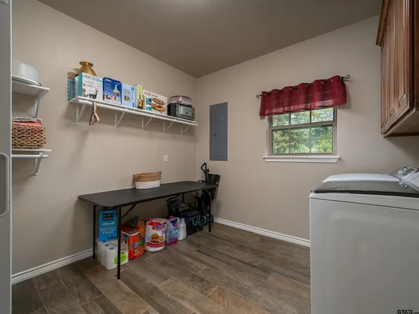 a kitchen with stainless steel appliances granite countertop a refrigerator oven a sink dishwasher and a stove with wooden floor