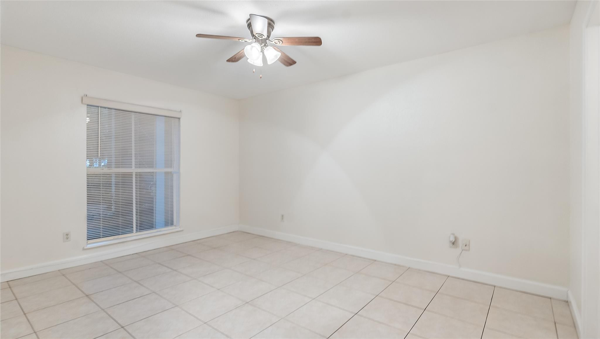 875 Riverside Drive, Unit 717 Coral Springs, FL 33071 - Photo 13 of 31 an empty room with a empty space and a window