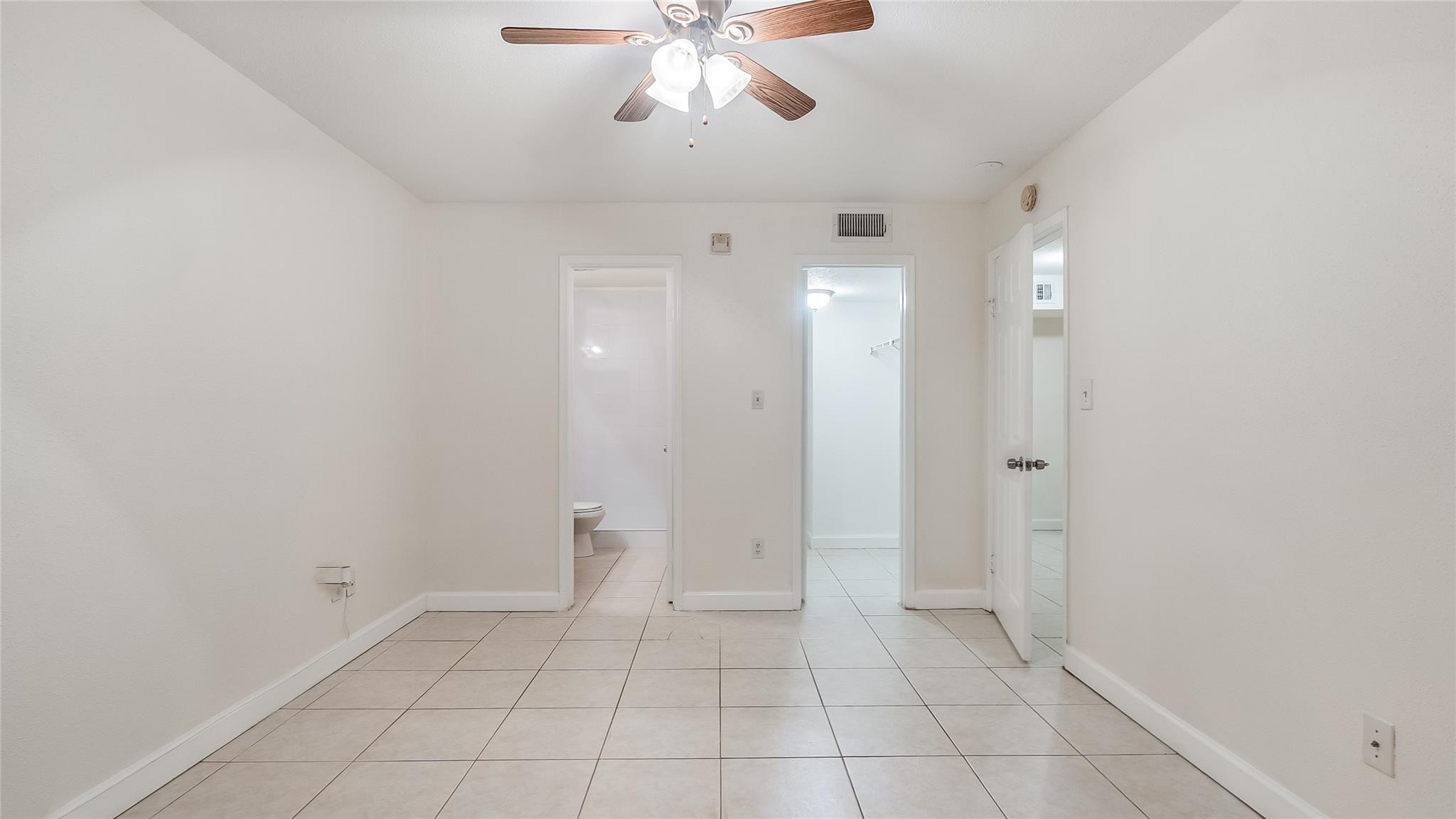 875 Riverside Drive, Unit 717 Coral Springs, FL 33071 - Photo 16 of 31 wooden floor in an empty room with a bathroom