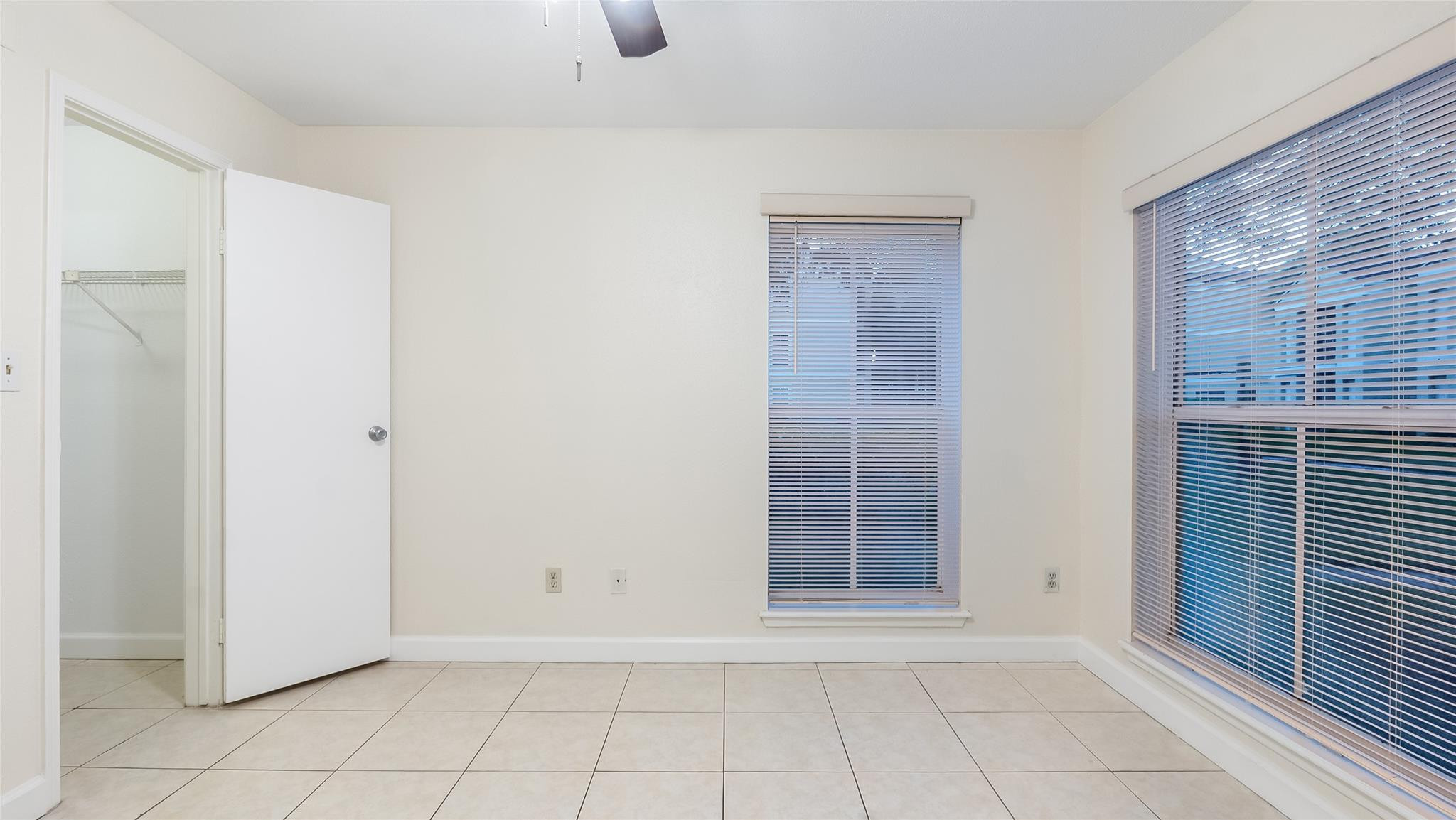 875 Riverside Drive, Unit 717 Coral Springs, FL 33071 - Photo 22 of 31 a view of an empty room with wooden floor and a window