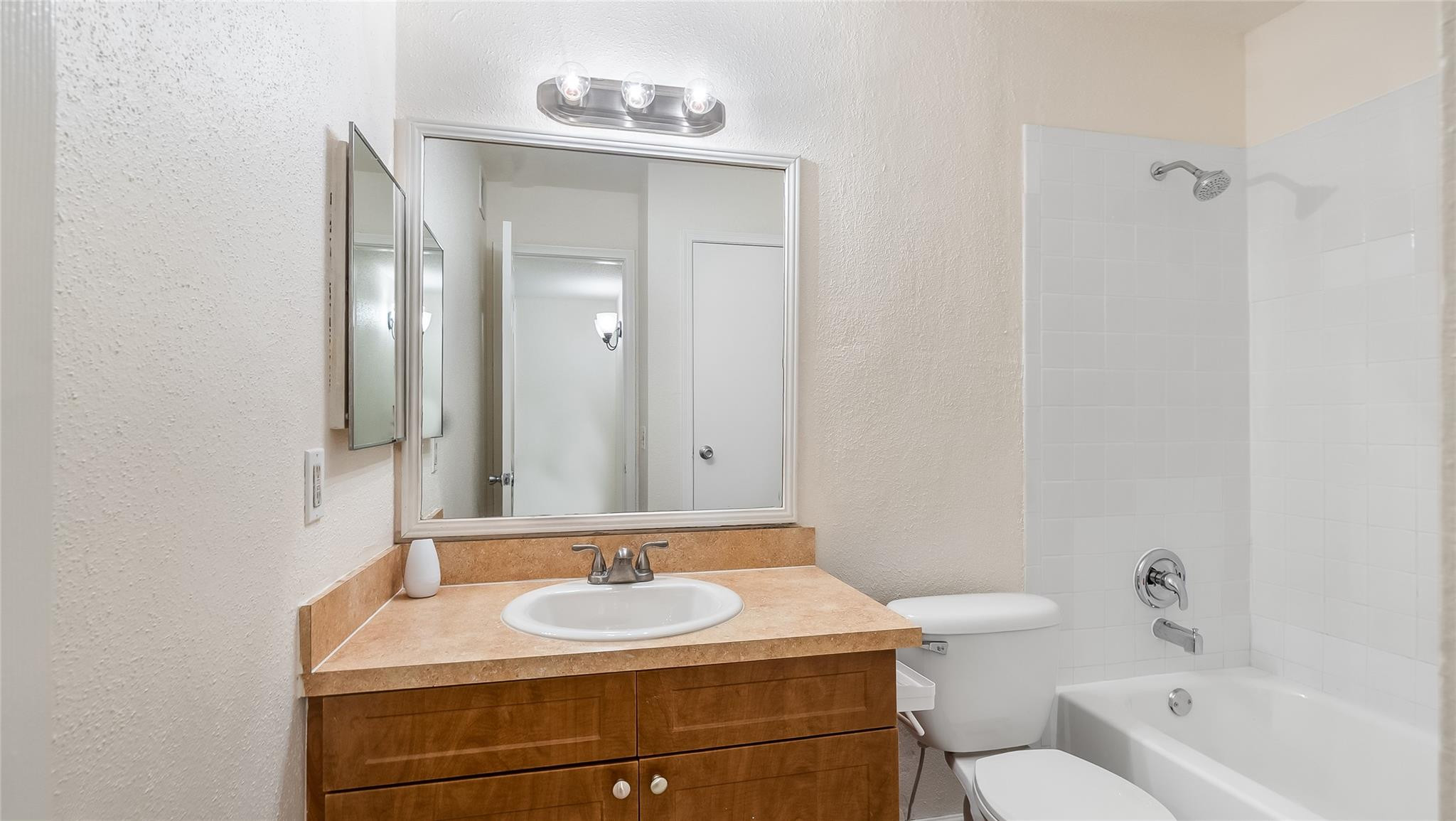 875 Riverside Drive, Unit 717 Coral Springs, FL 33071 - Photo 25 of 31 a bathroom with a sink toilet and mirror
