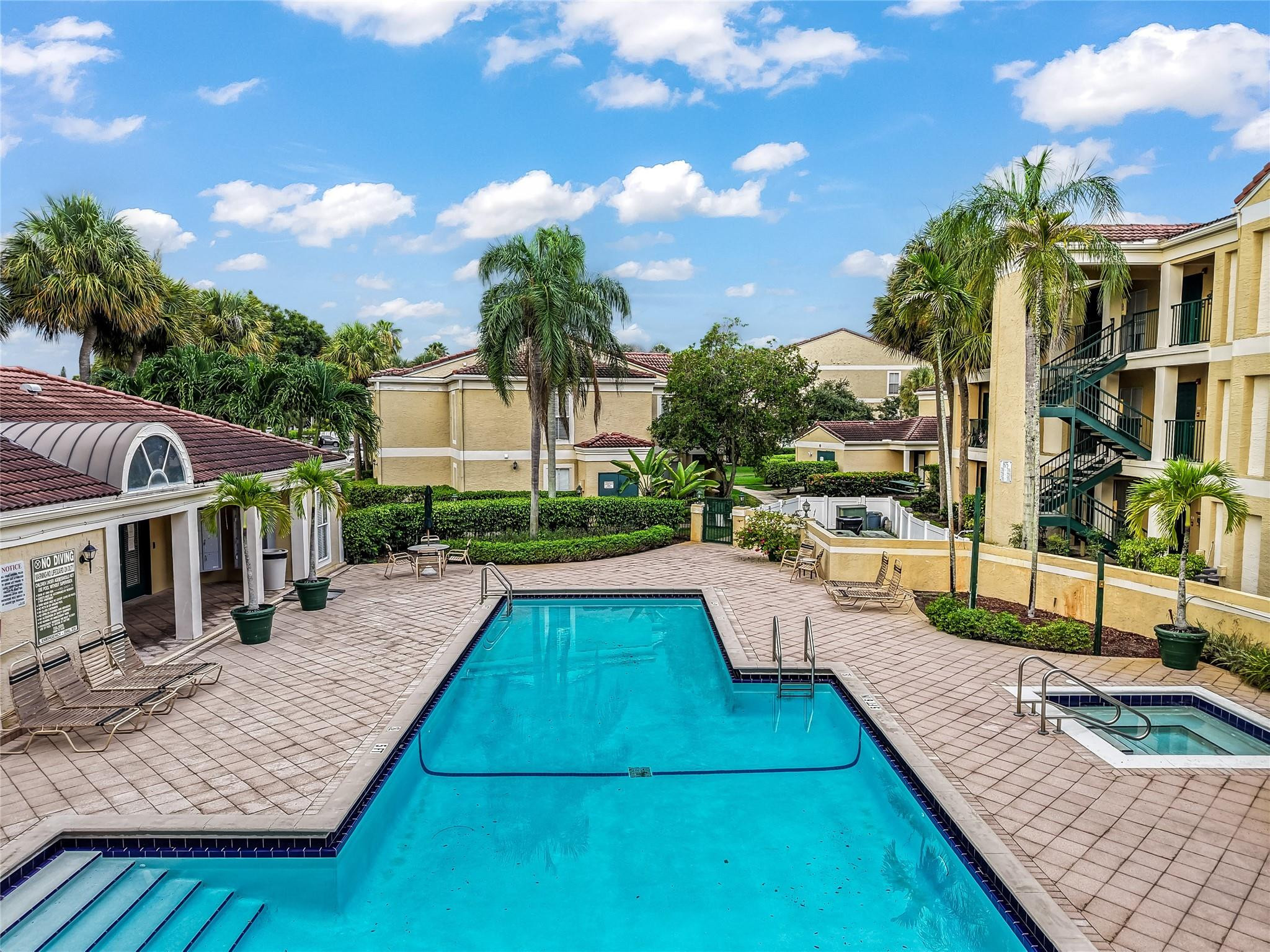 875 Riverside Drive, Unit 717 Coral Springs, FL 33071 - Photo 30 of 31 a view of a house with swimming pool and sitting area