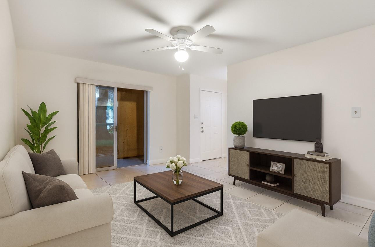 875 Riverside Drive, Unit 717 Coral Springs, FL 33071 - Photo 3 of 31 a living room with furniture and a flat screen tv