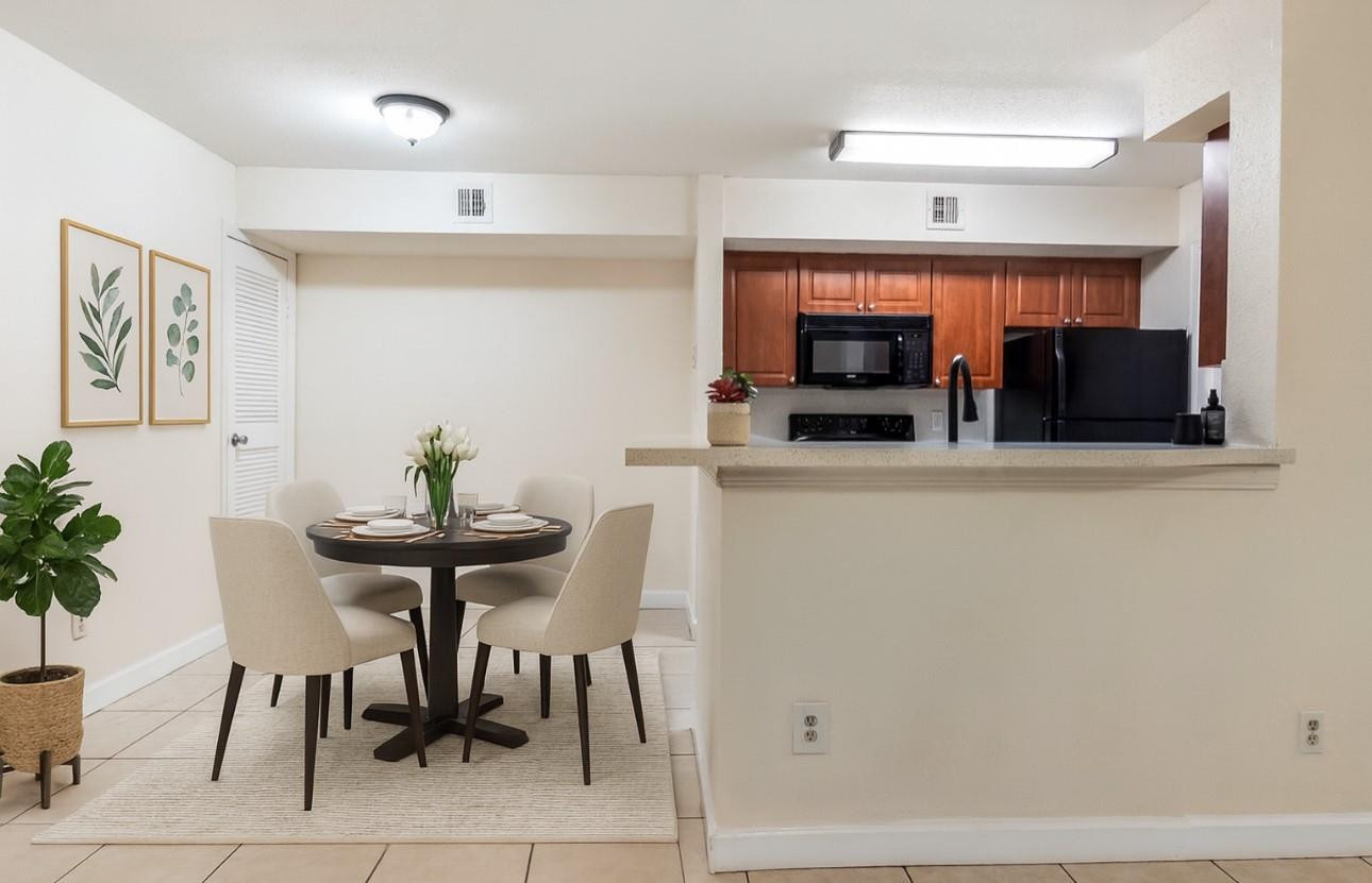 875 Riverside Drive, Unit 717 Coral Springs, FL 33071 - Photo 5 of 31 a kitchen with a table and chairs in it