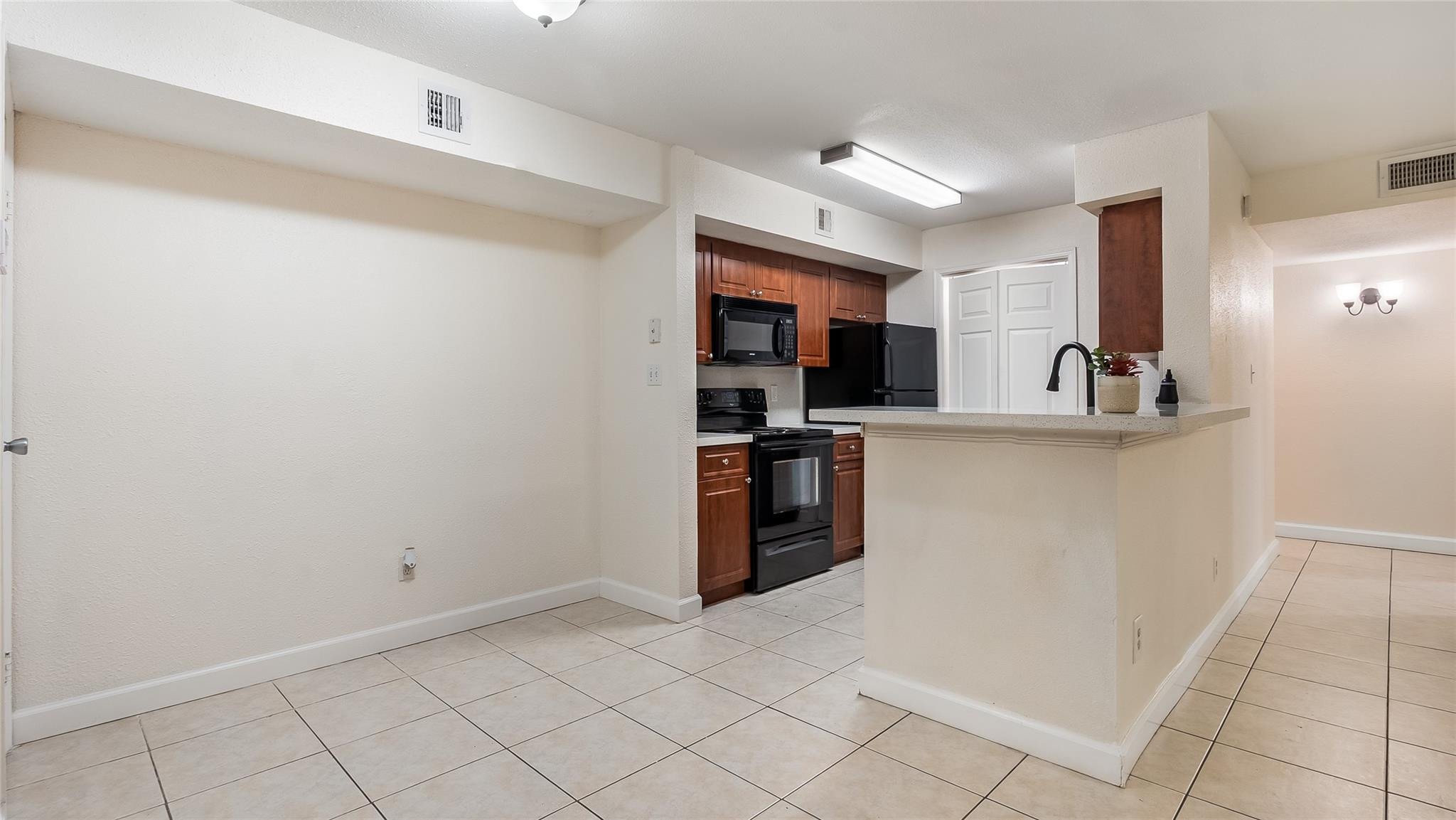 875 Riverside Drive, Unit 717 Coral Springs, FL 33071 - Photo 7 of 31 a kitchen with stainless steel appliances granite countertop a refrigerator and a sink
