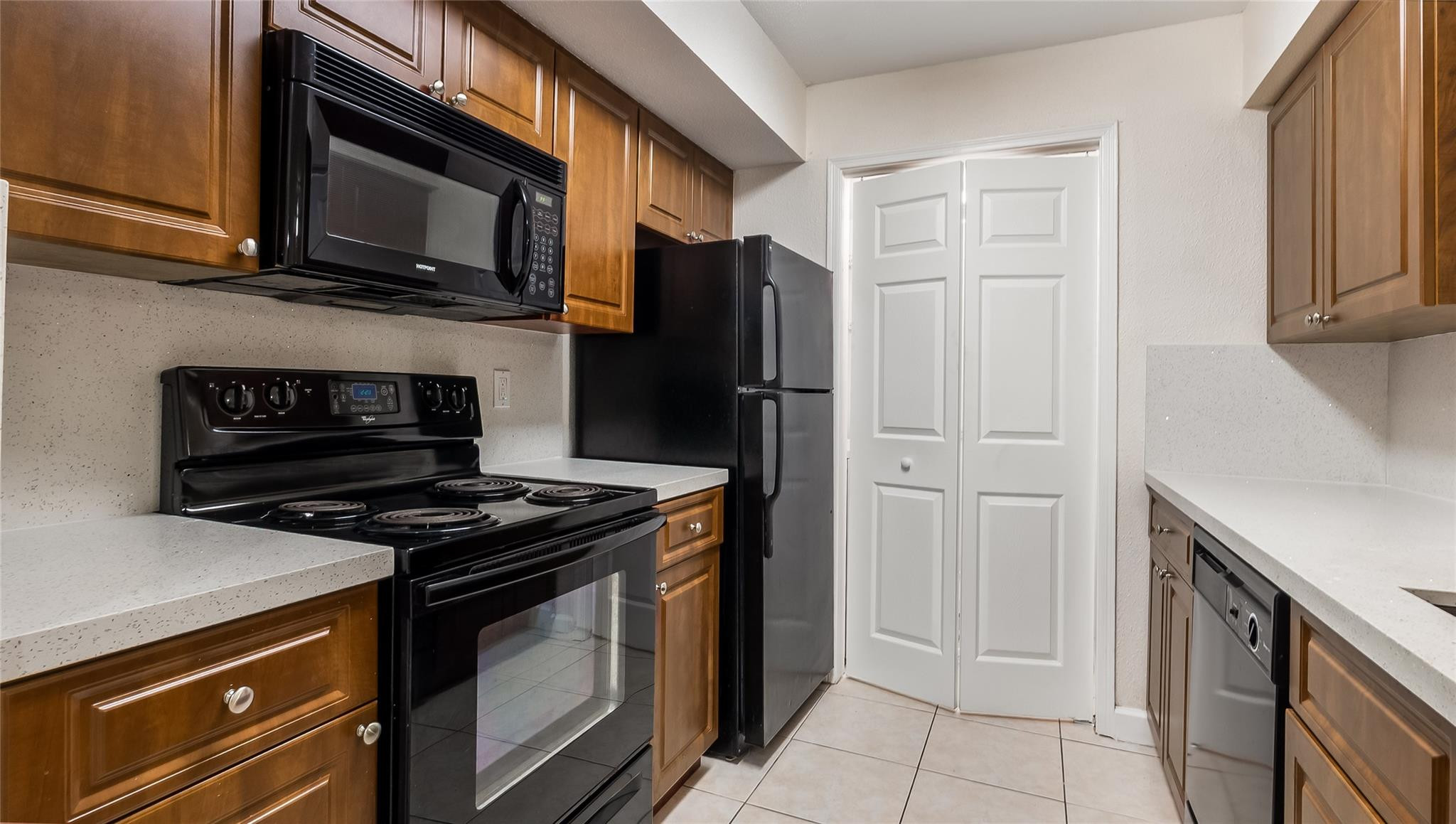 875 Riverside Drive, Unit 717 Coral Springs, FL 33071 - Photo 8 of 31 a kitchen with stainless steel appliances granite countertop a stove microwave and refrigerator