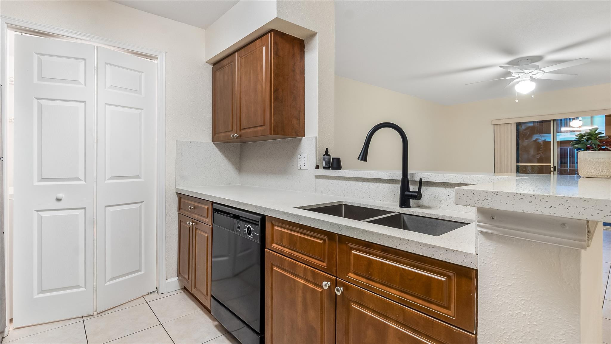 875 Riverside Drive, Unit 717 Coral Springs, FL 33071 - Photo 9 of 31 a kitchen with kitchen island granite countertop a sink and cabinets