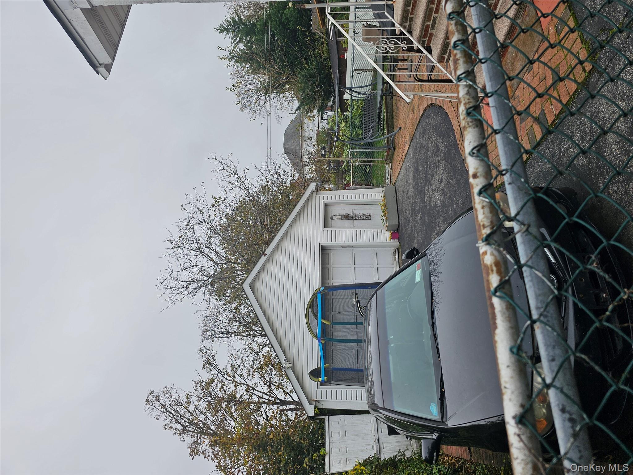 232 Doughty Boulevard Inwood, NY 11096 - Photo 11 of 11 a backyard of a house with table and chairs