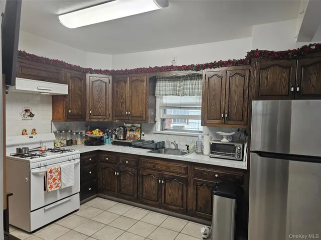 a kitchen with a sink stove and refrigerator