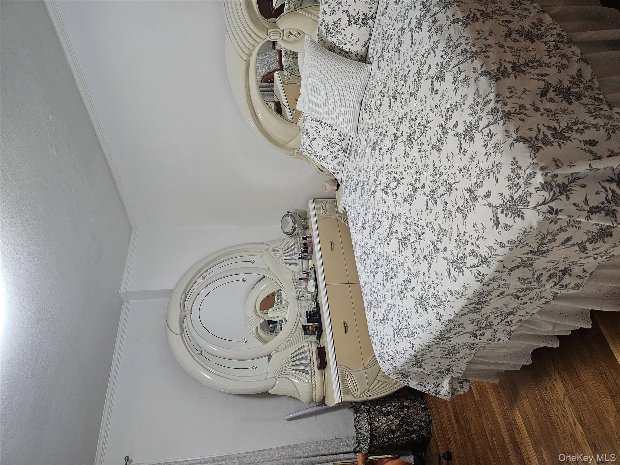 232 Doughty Boulevard Inwood, NY 11096 - Photo 7 of 11 a bedroom with a bed and wooden floor