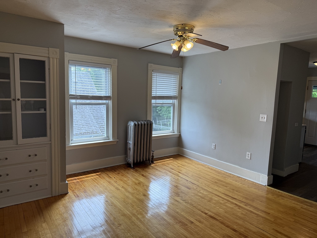 5 Arbor Vitae Street, Unit 2 Worcester, MA 01603 - Photo 5 of 12 an empty room with cabinet and wooden floor