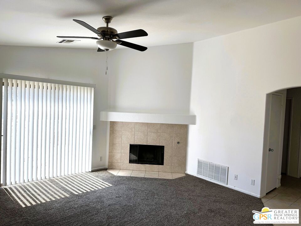 9700 Santa Cruz Road Desert Hot Springs, CA 92240 - Photo 13 of 37 a view of an empty room with a fireplace and a window