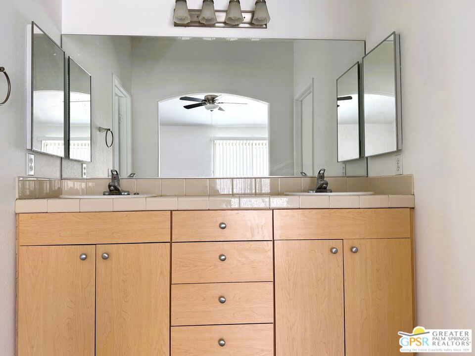 9700 Santa Cruz Road Desert Hot Springs, CA 92240 - Photo 24 of 37 a bathroom with a double vanity sink and mirror