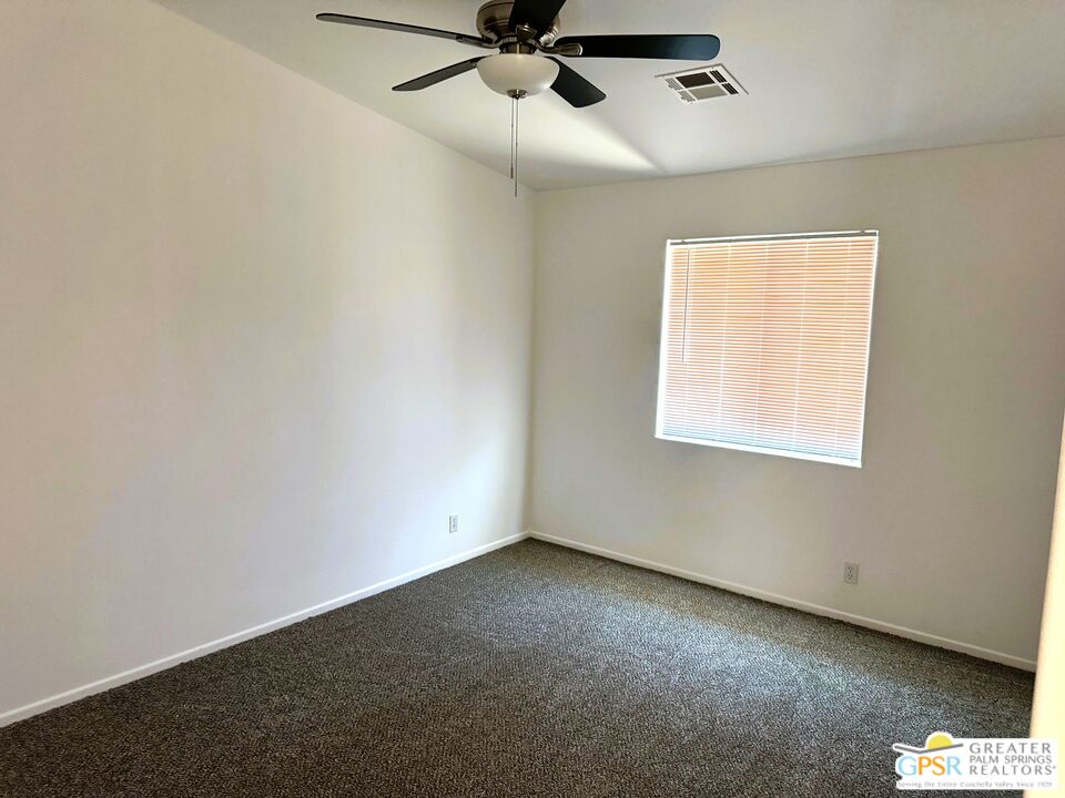 9700 Santa Cruz Road Desert Hot Springs, CA 92240 - Photo 30 of 37 an empty room with a window and a fan