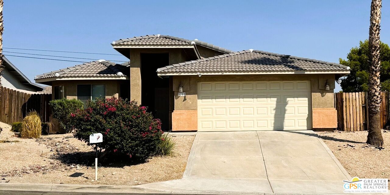 9700 Santa Cruz Road Desert Hot Springs, CA 92240 - Photo 3 of 37 a front view of a house with a yard