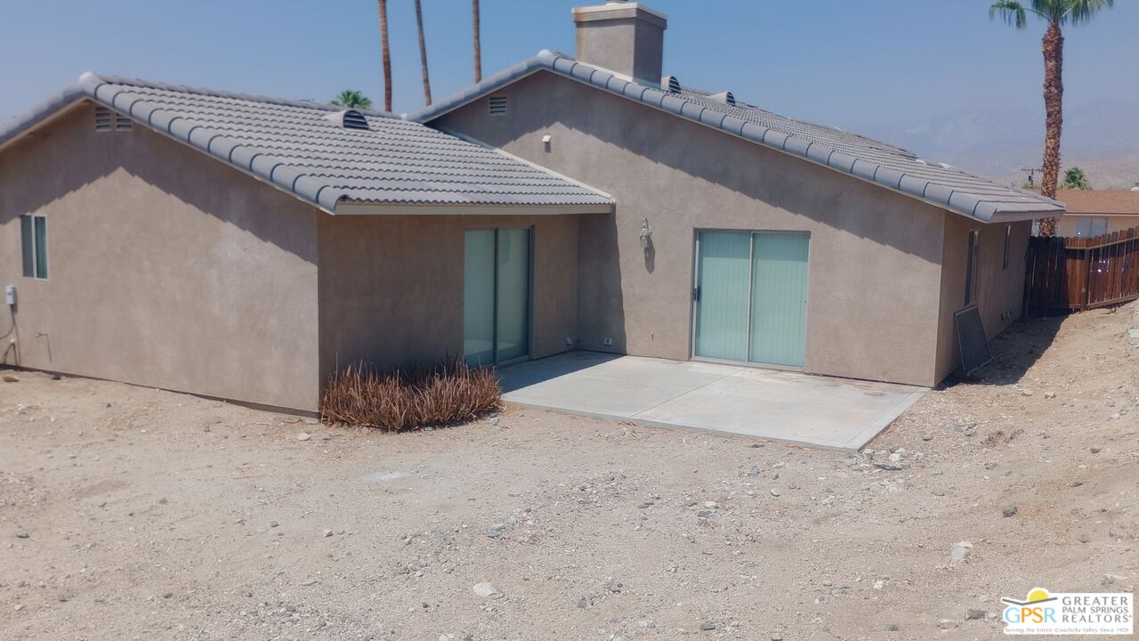 9700 Santa Cruz Road Desert Hot Springs, CA 92240 - Photo 36 of 37 a view of a house with a yard and garage