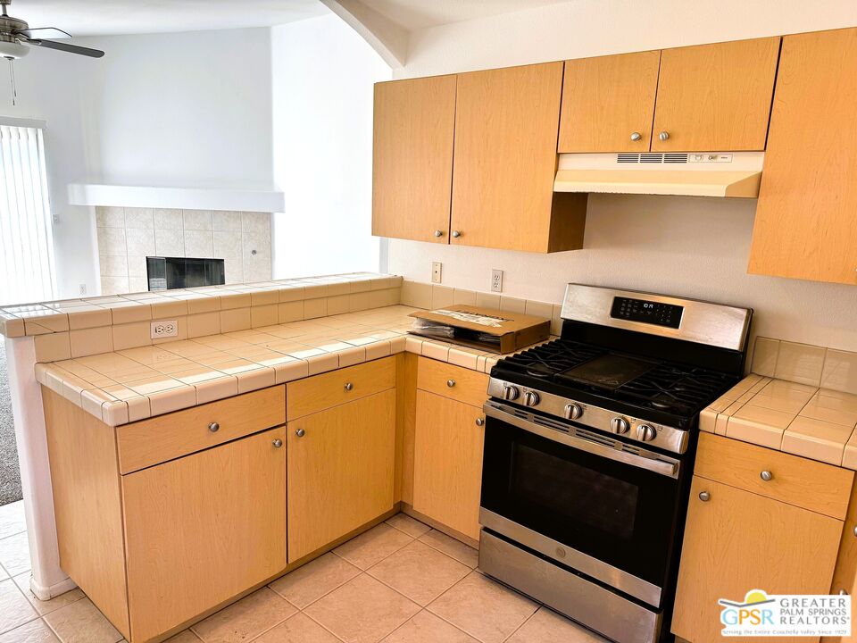 9700 Santa Cruz Road Desert Hot Springs, CA 92240 - Photo 7 of 37 a kitchen with a stove and a sink