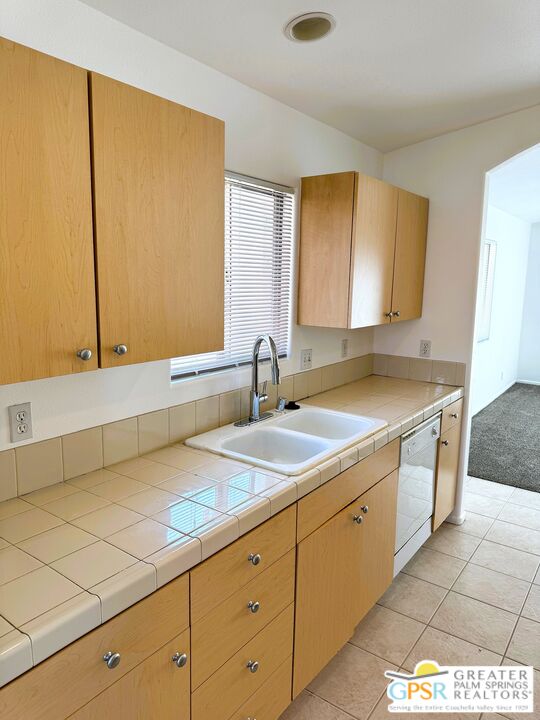 9700 Santa Cruz Road Desert Hot Springs, CA 92240 - Photo 8 of 37 a kitchen with a sink and cabinets
