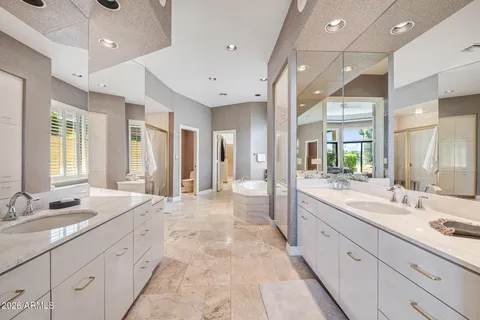 a large bathroom with a large mirror vanity and double sink