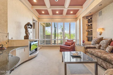 a living room with furniture and ceiling windows