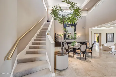 a dining room with furniture and a potted plant