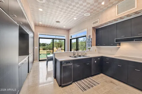 a kitchen with a sink and large cabinets