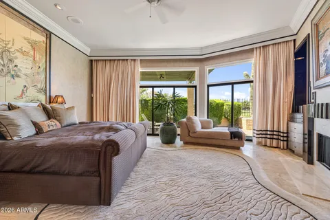 a spacious bedroom with a large bed and a large window
