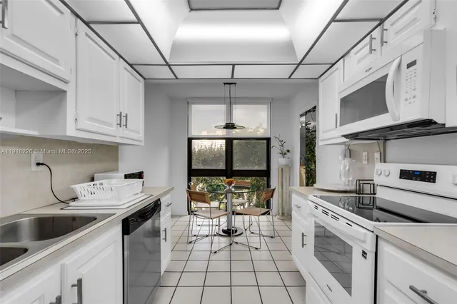 a kitchen with a sink cabinets and window