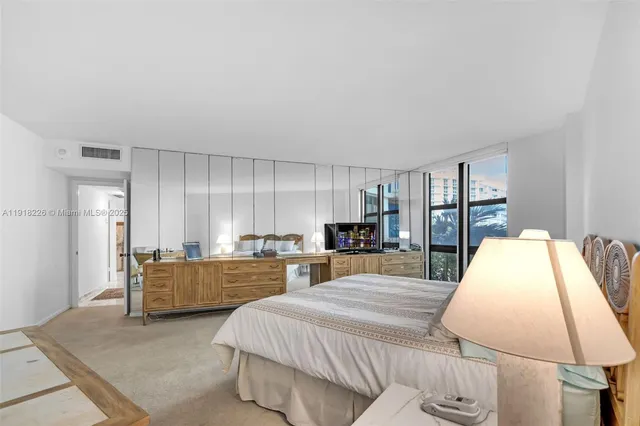 a large bedroom with a bed and window