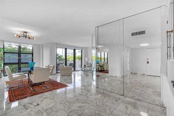 a living room with furniture and large windows