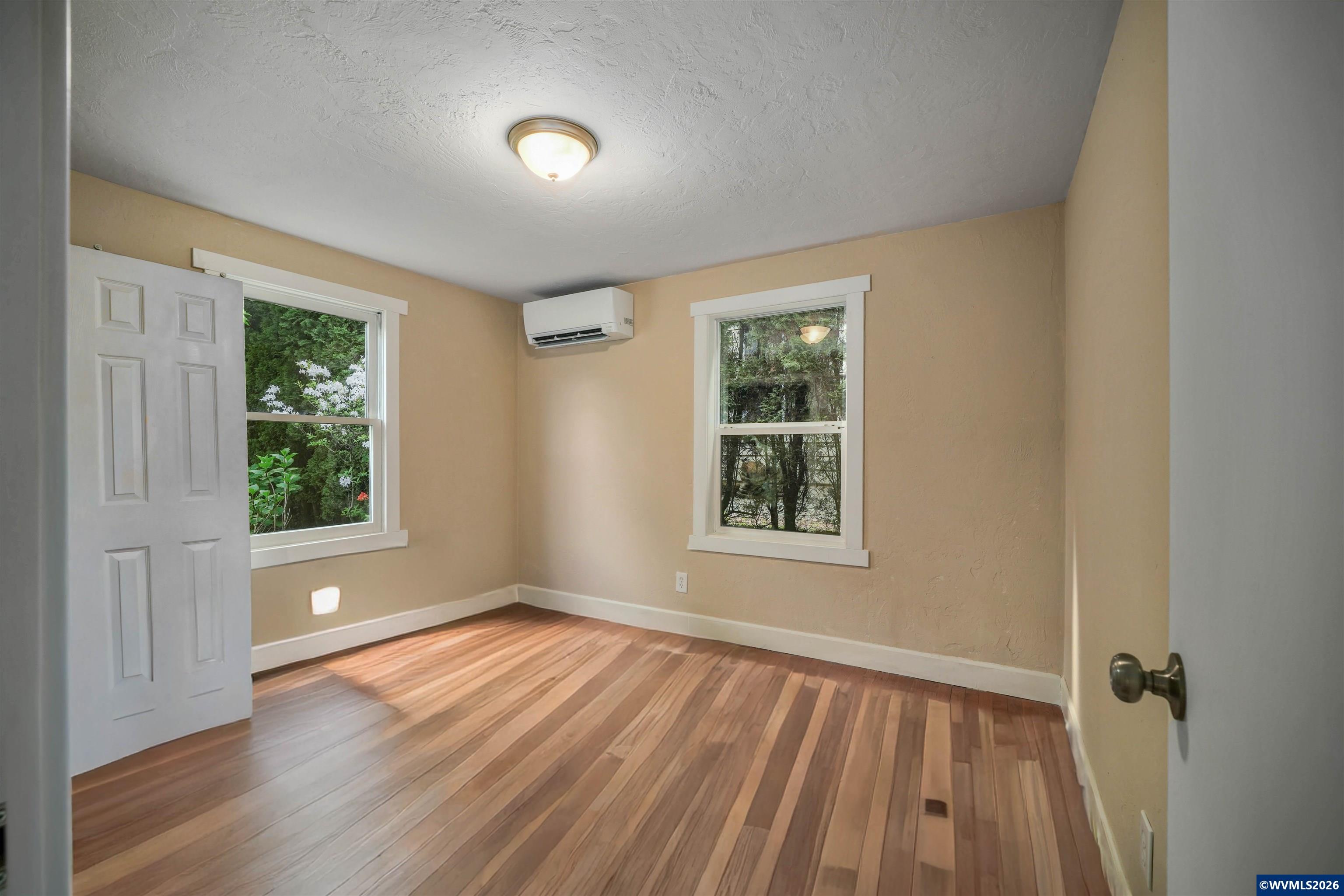 220 Northwest Downy Drive Sublimity, OR 97385 - Photo 23 of 47 an empty room with wooden floor and windows