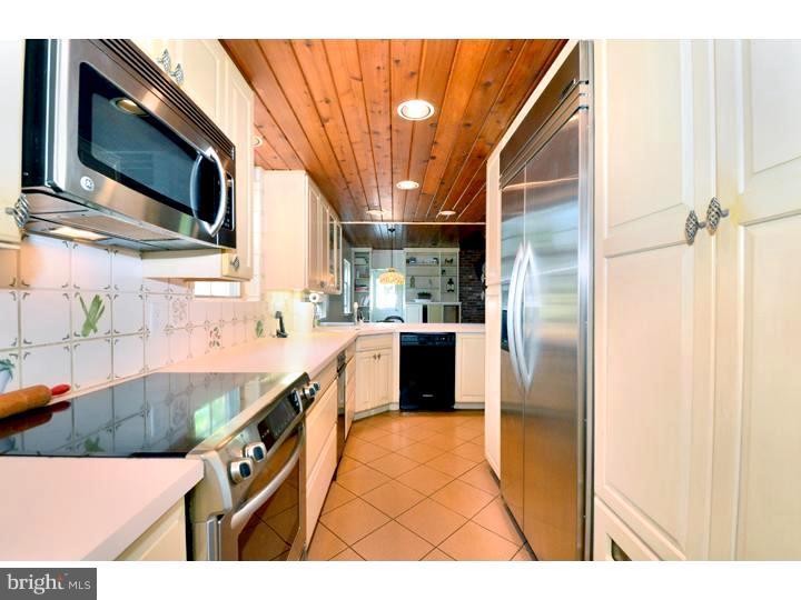 344 Penn Road Wynnewood, PA 19096 - Photo 8 of 25 a kitchen with stainless steel appliances kitchen island granite countertop a refrigerator and a sink