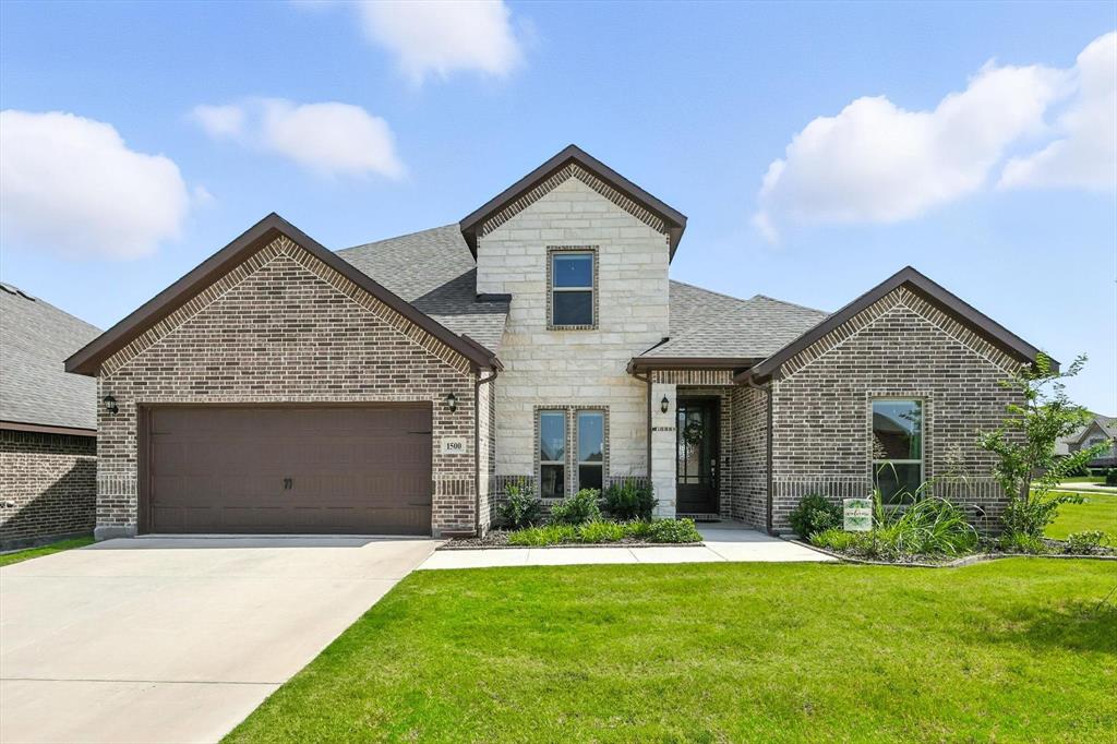 1500 Radecke Road Krum, TX 76249 - Photo 1 of 1 a front view of a house with a yard and garage