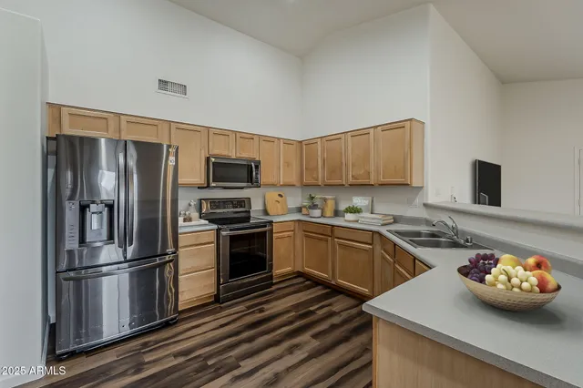 a kitchen with stainless steel appliances and wooden cabinets