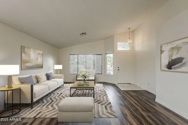 a living room with furniture and wooden floor