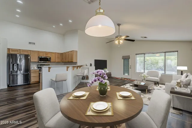 a view of a dining room with furniture a chandelier and wooden floor