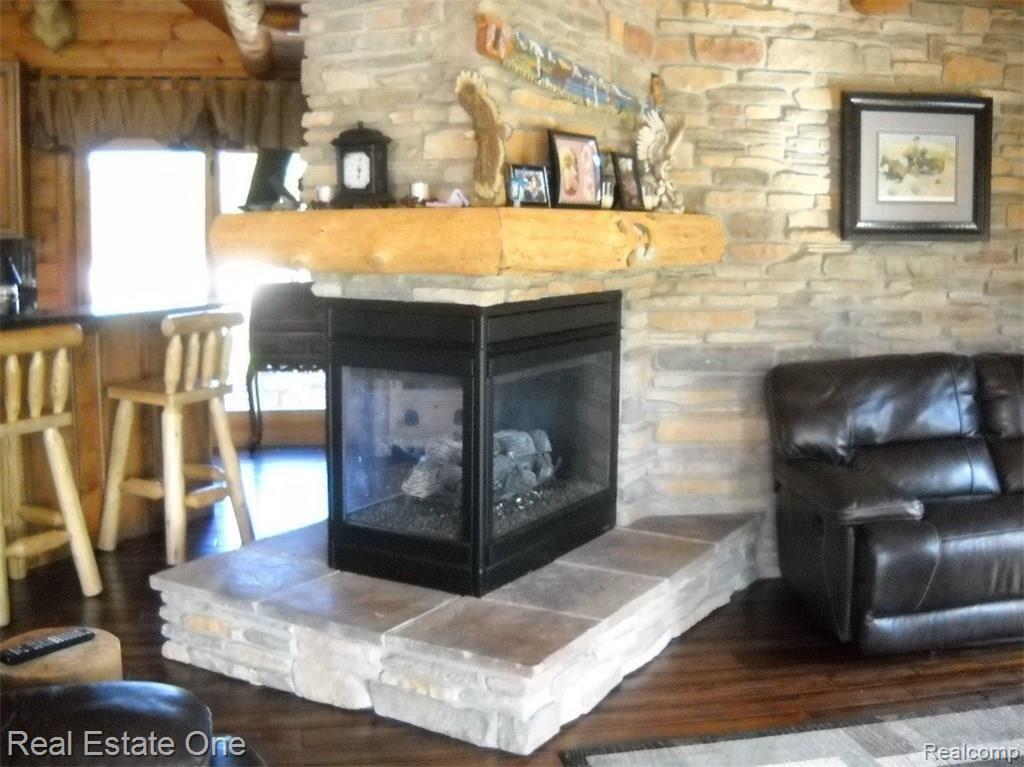 11611 Newman Road Brighton, MI 48114 - Photo 15 of 23 Three sided fire place.JPG