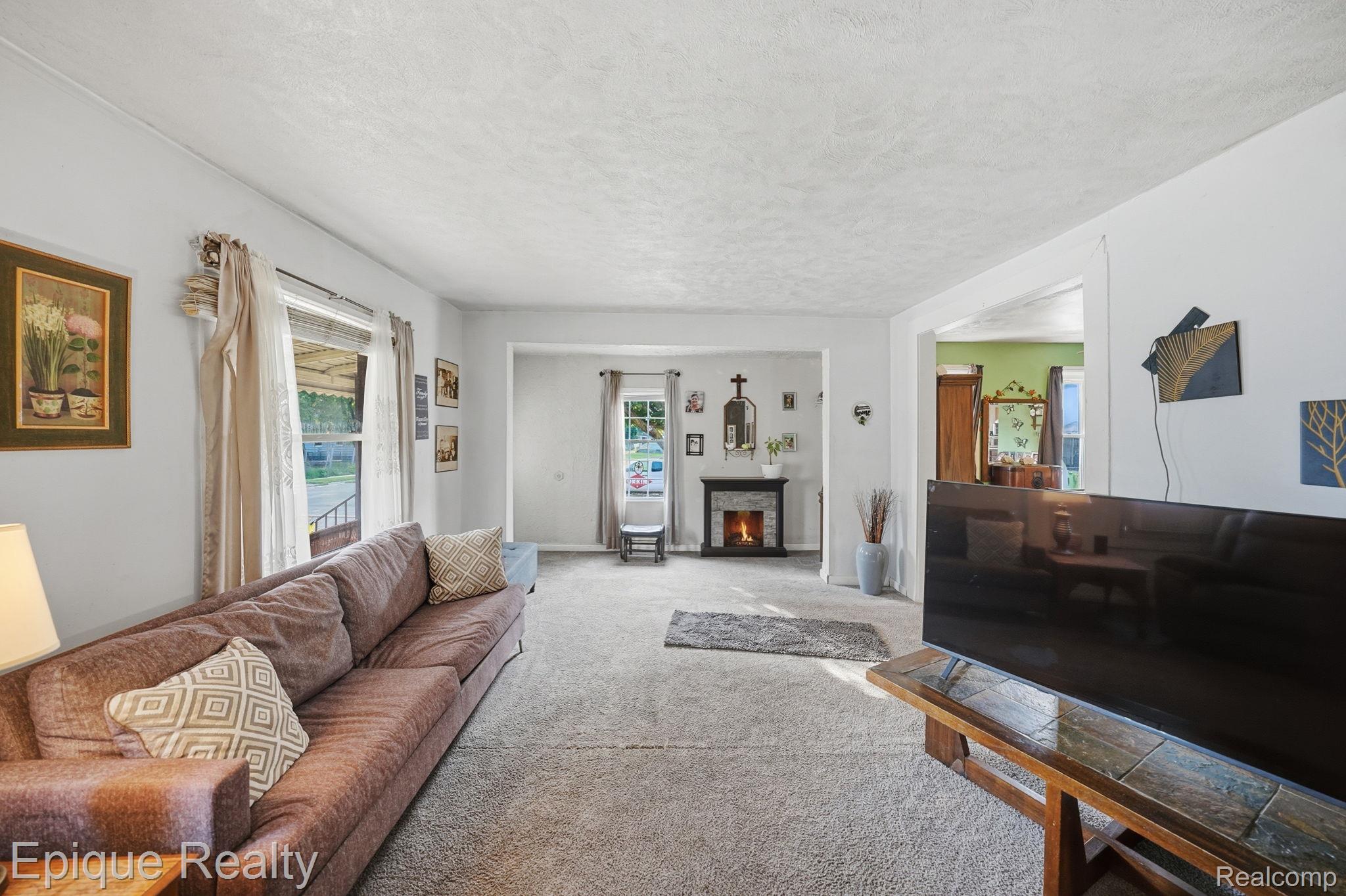 75 East Cicotte Street River Rouge, MI 48218 - Photo 8 of 25 Living area featuring neutral-toned carpeting and light-colored walls