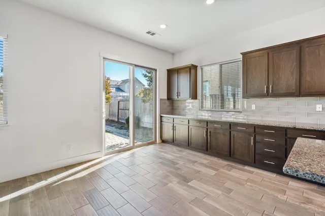 a spacious bathroom with a granite countertop sink and mirror