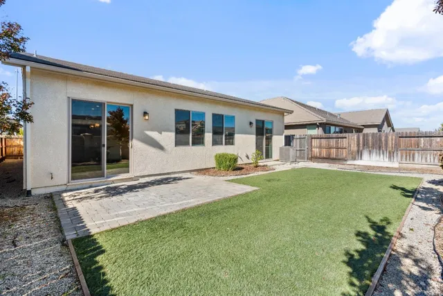 a view of a house with a backyard and porch