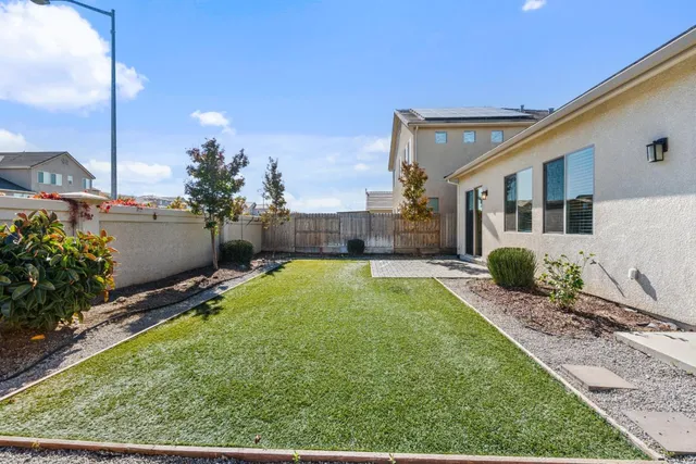 a view of backyard with swimming pool
