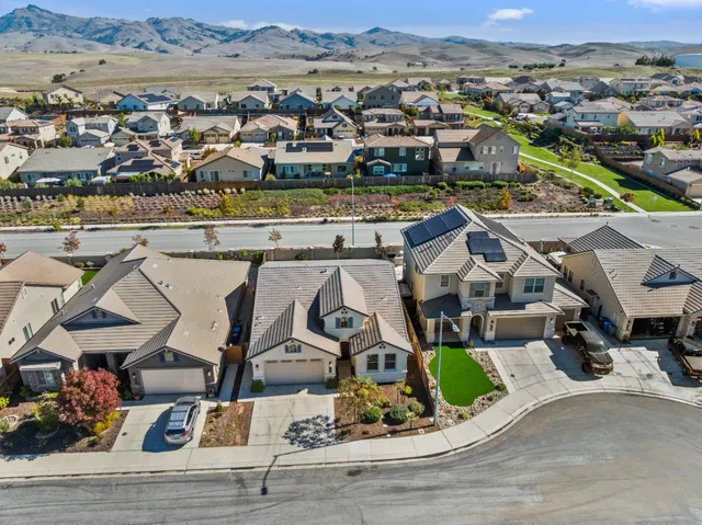 an aerial view of a house with a ocean view