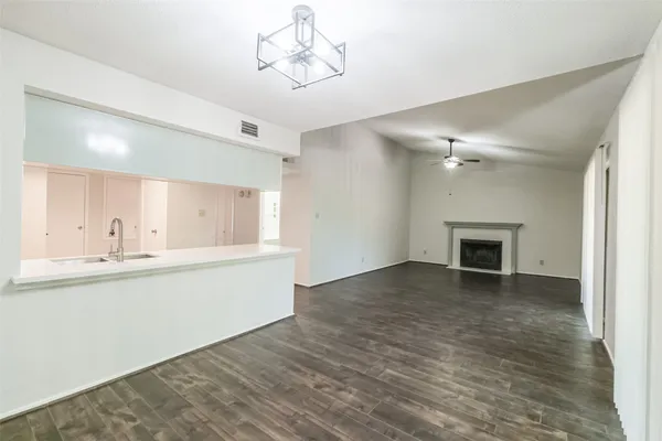 a view of a kitchen with a sink cabinets and wooden floor