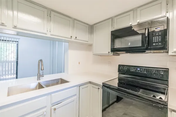 a kitchen with a sink and cabinets