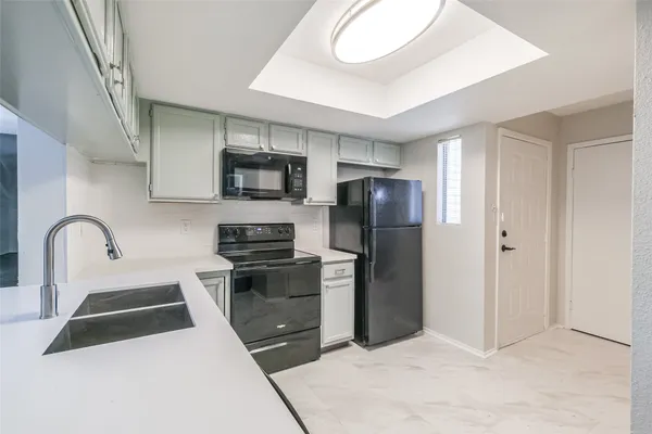 a kitchen with stainless steel appliances a refrigerator sink and microwave