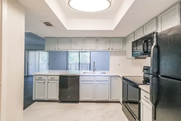 a kitchen with a sink stove and refrigerator